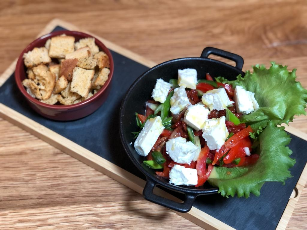 Baked red pepper salad with sheep cheese
